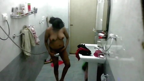 Busty brunette in sexy bikini gets naked in the bathroom